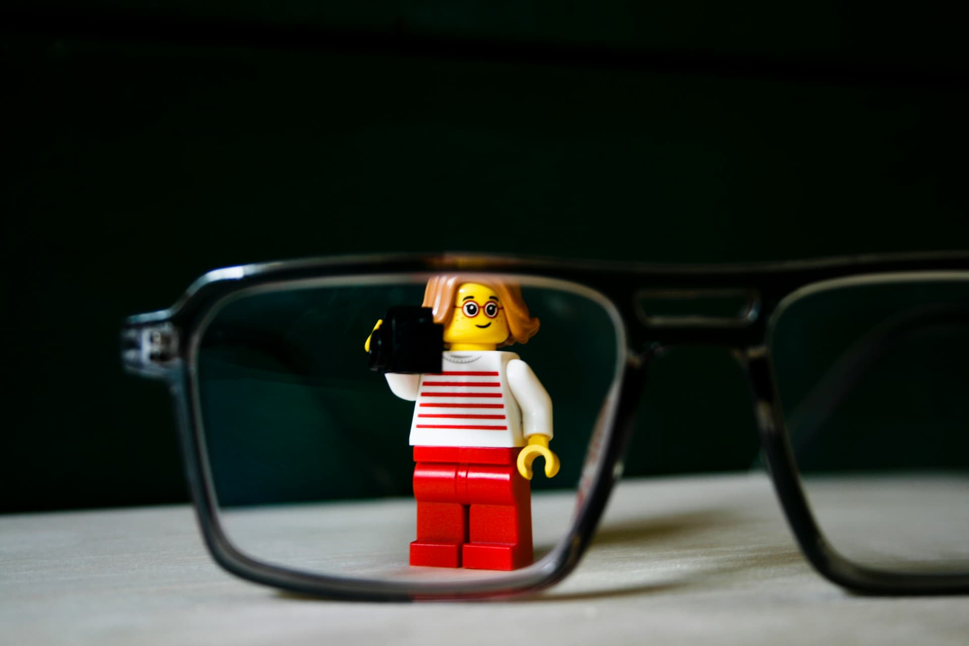 A lego man wearing a red and white shirt and glasses